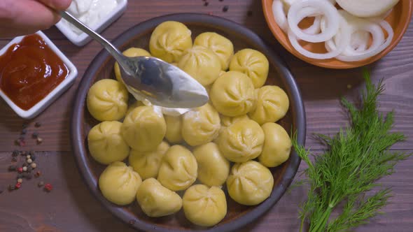 Top View of Delicious Khinkali Laid on Clay Plate