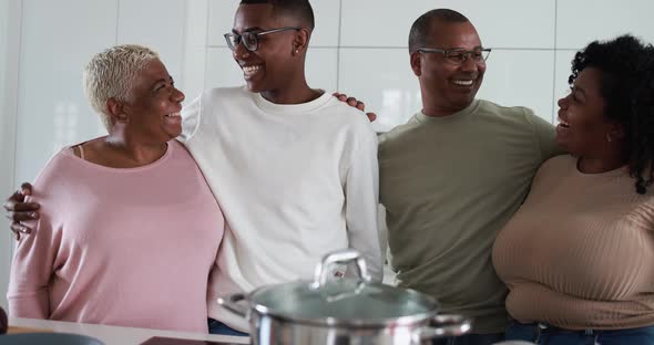 Happy latin family cooking inside kitchen at home