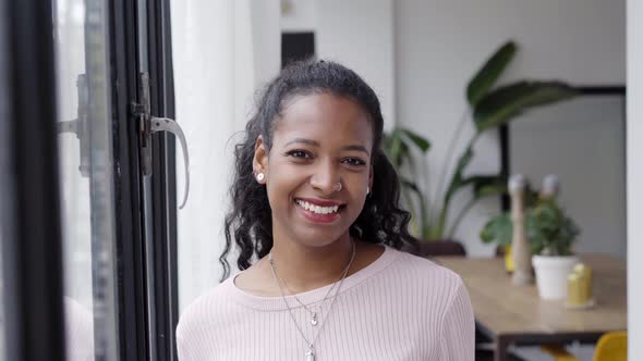 Cheerful Beautiful African Woman Professional Standing at Home in Office Looking at Camera