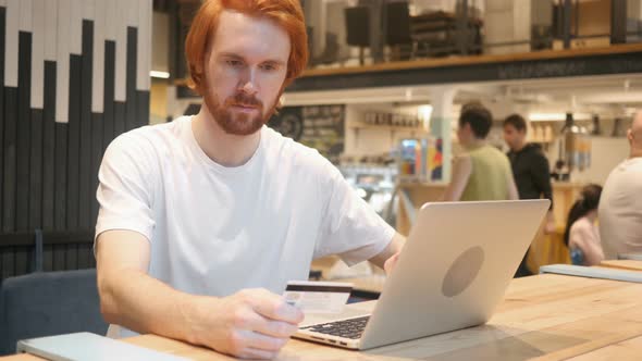 Online Shopping by Redhead Beard Man in Cafe, Credit Card