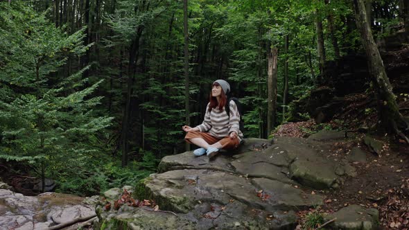 Tourist Woman on Mountain Excursion High on Cliff Looking the Distant Beautiful Landscape Forests