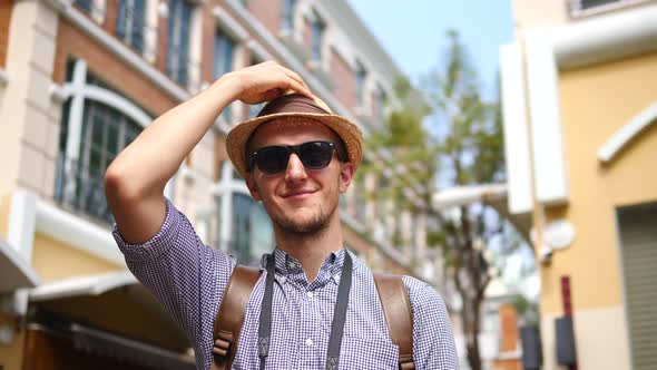 Portrait Of Tourist Man In Hipster Hat And Sunglasses Sightseeing In City