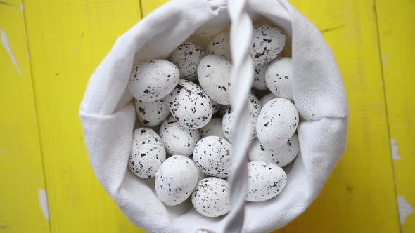 Quail Eggs In White Wicker Basket. The Concept of Easter Holidays