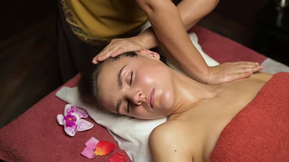 Young woman relaxes on thai massage