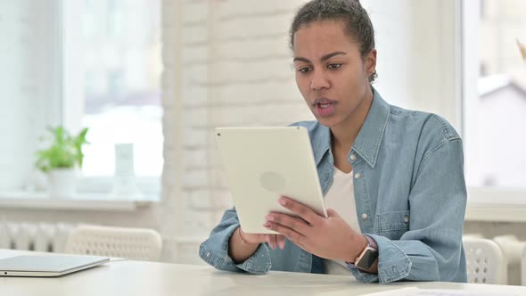 Young African Woman Reacting To Loss on Tablet