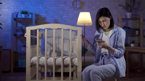 Single Young Mother Searches Internet Smartphone Her Hands Newborn Baby Bed