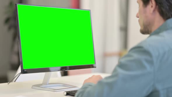 Man using Desktop with Green Chroma Key Screen