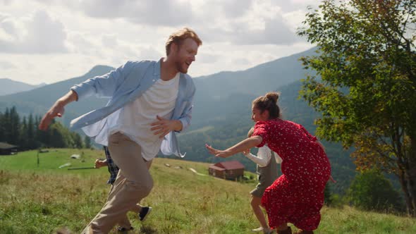 Family Running Mountain Slope Sunny Day