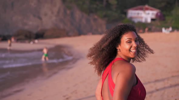 Carefree laughing woman running on the beach