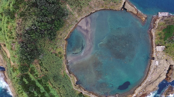 Flight over a volcanic island in the Atlantic Ocean,  sandy beach and blue sea waters