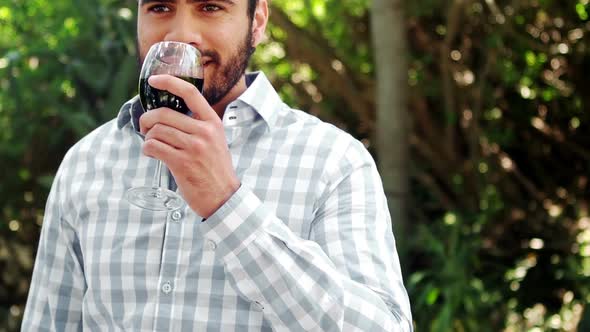 Man drinking glass of red wine