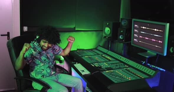 Musician and sound male engineer mixing new album inside boutique recording studio