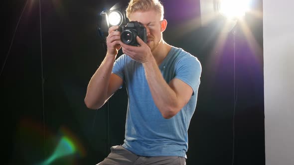 Male photographer photographing with digital camera