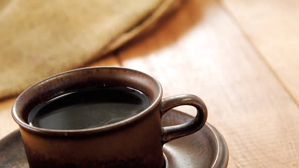 Black coffee served in brown cup