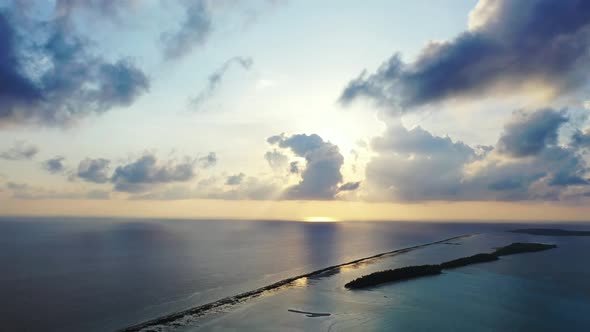 Aerial drone shot abstract of relaxing coastline beach journey by blue lagoon with white sandy backg