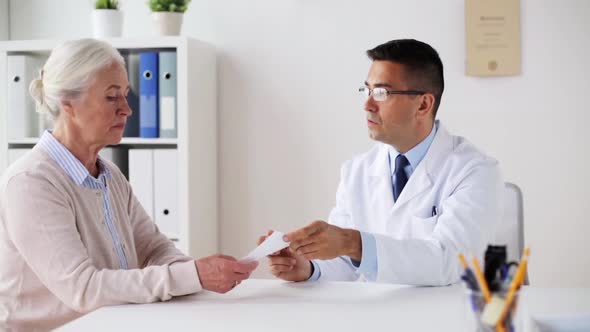 Woman and Doctor with Prescription at Clinic