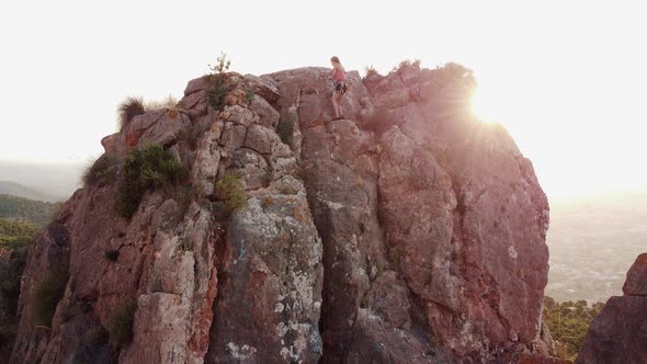 Climbing mountain in Spain. Drone aerial view of climber woman and man that climb a big rock.