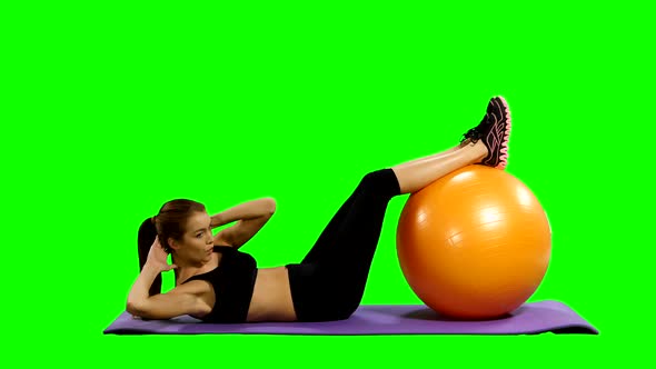 Sport Woman in Gym Outfit Excercising with a Pilates Ball, Green Screen