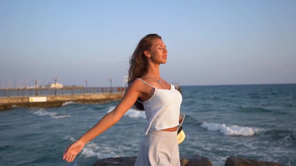 Young Tanned Woman Enjoying the Sun and Sea in Summer