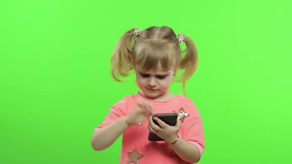 Little Girl Using Smartphone. Portrait of Child with Smartphone Texting, Playing