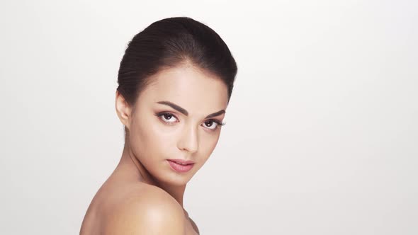 Studio portrait of young and beautiful brunette woman over