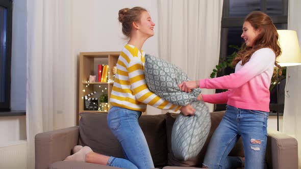 Happy Teenage Having Pillows Fight at Home