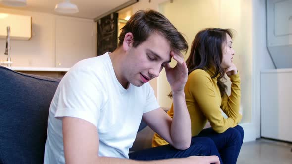 Couple ignoring each other while argument in living room