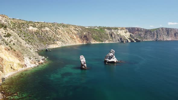 Aerial View From Above on Calm Azure Sea and Volcanic Rocky Shores