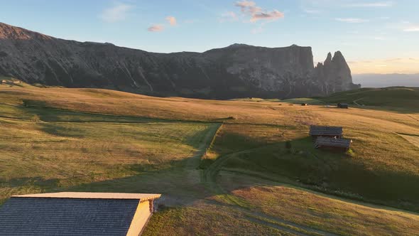 Dolomites cottages under the rugged peaks at sunrise