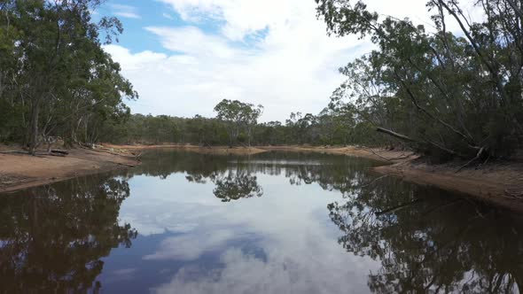 Aerial footage of a drought affected agricultural water reservoir in regional Australia