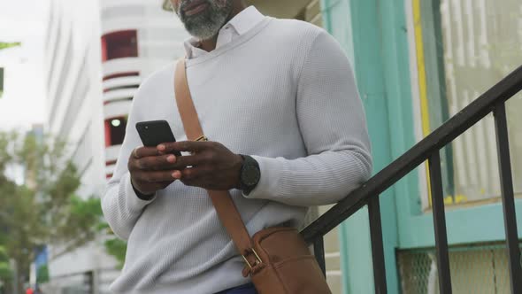 African American man using his phone in the street