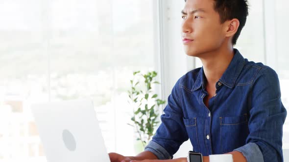 Man thinking using laptop