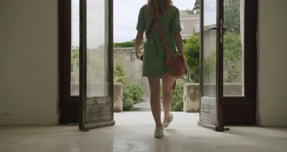 A young woman photographer is entering in the garden of San Giacomo's Certosa in Capri