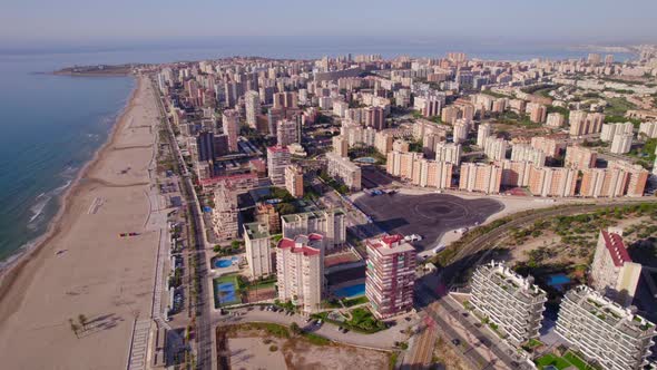 panoramic aerial of San Juan Playa beach with residential buildings at sunrise in Alicante, Spain
