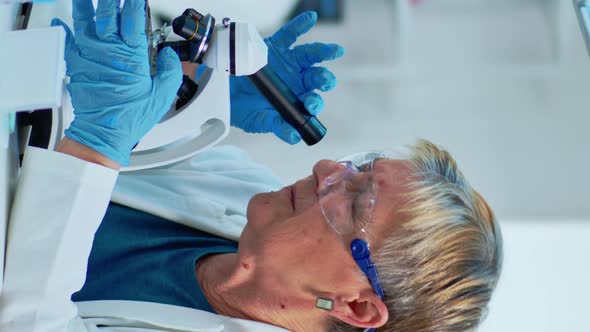 Vertical Video Elderly Biotechnology Scientist Researching in the Laboratory