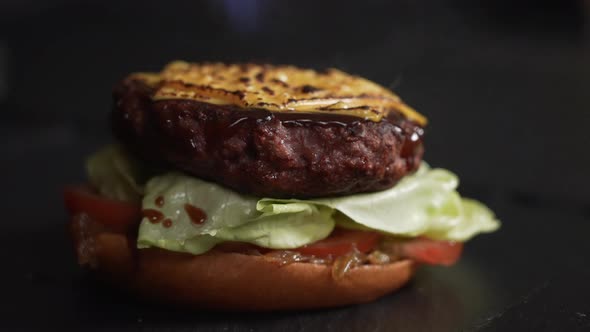 Chef Grills American Cheese On a Gourmet Chicken Burger With a Kitchen Blow Torch. Macro close up sh