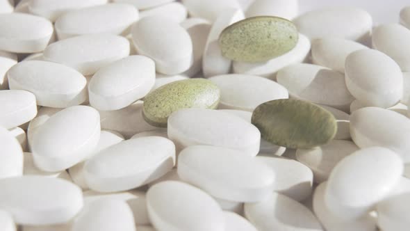 New natural green pills are falling on top of ordinary white chemical medicines.