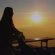 A young sad girl watches watching the sunset - VideoHive Item for Sale