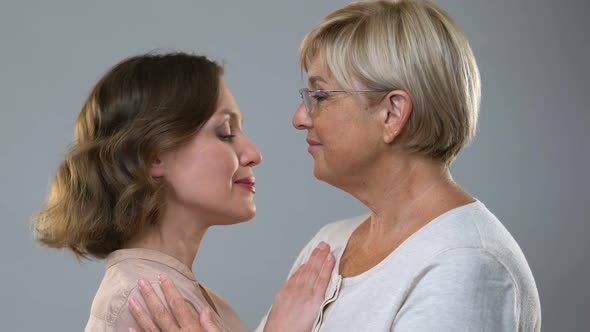 Mother Hugging Adult Daughter Isolated on Background, Parental Love and Support