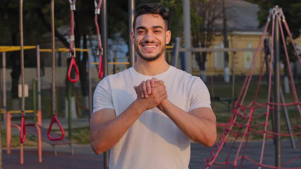 Young Arabic Male Athlete Shows Handshake Gesture Demonstrates Community Support Wishes Success and