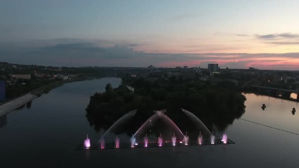 Musical Fountain Show. Aerial shot of the beautiful fountain show with reflection on water at night