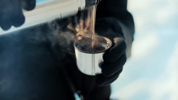 Woman Pouring Tea Into Cup. Hot Coffee From Thermos. Holiday Vacation Trip And Relaxing Moment.