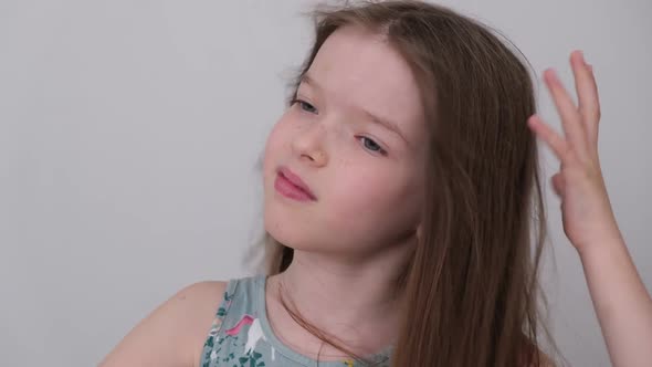 Little Cute Girl Combing Her Hair and Drying It