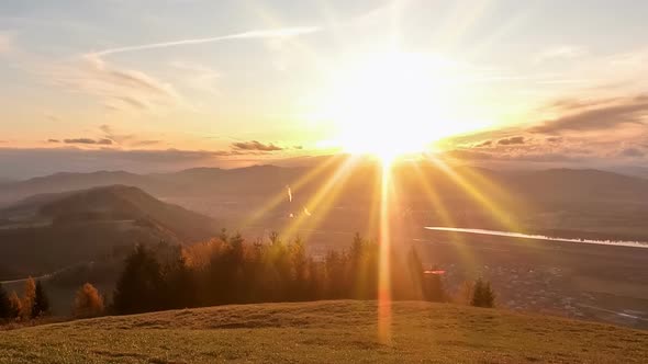 Beautiful Sunrise over Small City in Alpine Mountains Landscape in Autumn Morning in Europe