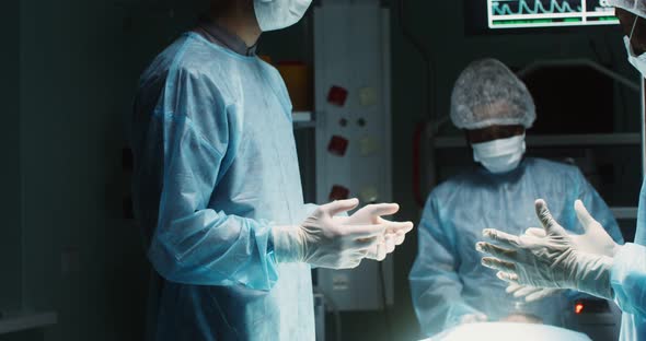 A Team of Surgeons Perform an Operation in a Bright Operating Room