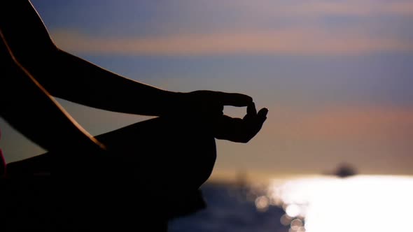 Woman performing yoga on the beach