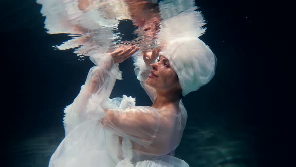 Underwater Fantasy with Fabulous Fairy Lady in White Gown Woman is Swimming Under Water