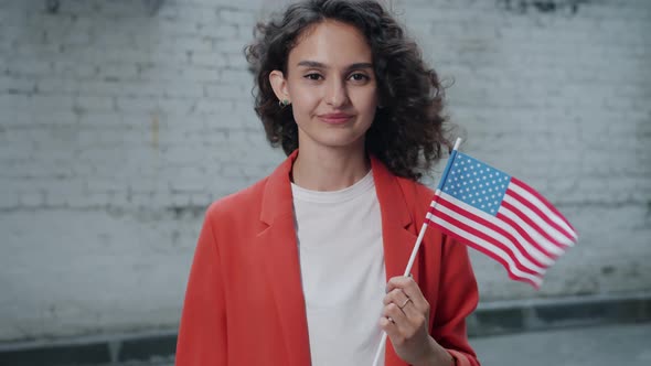 Slow Motion Portrait of Happy Mixed Race Lady Holding US National Flag Smiling Standing Outside