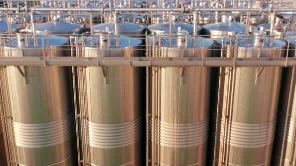 Shiny silos in a chemical factory - stainless steel containers in chemical industry plant