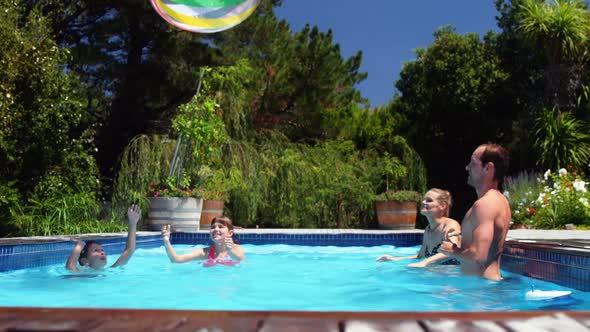 Happy family having fun in swimming pool